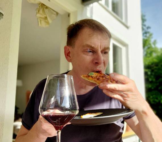 Warren Laine-Naida eating pizza for SEO social media image post