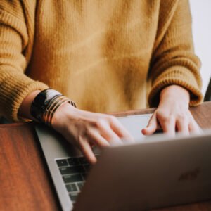 woman's hands on laptop keyboard