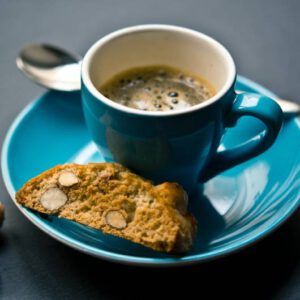 a cup of espresso and a biscotti