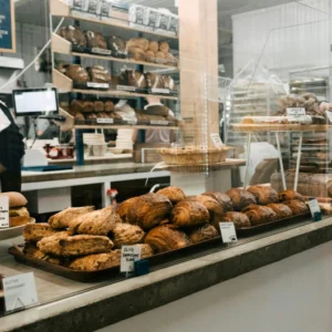 a bakery shop counter with bread and baked goods on display