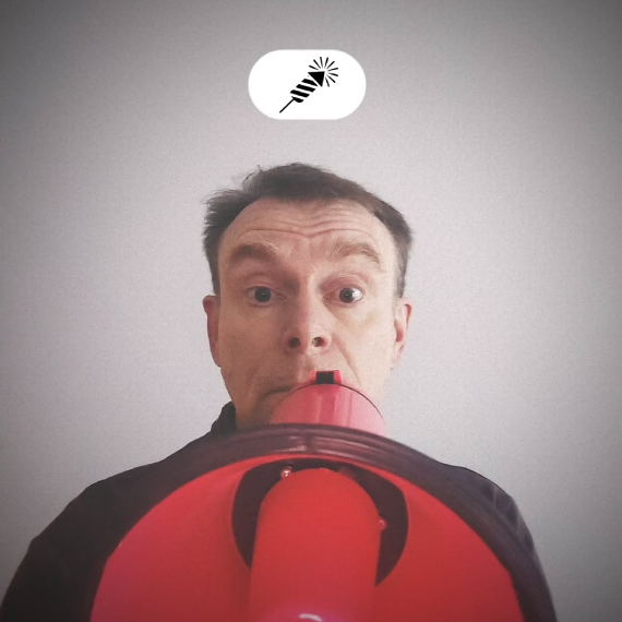 Warren Laine-Naida speaking with a megaphone