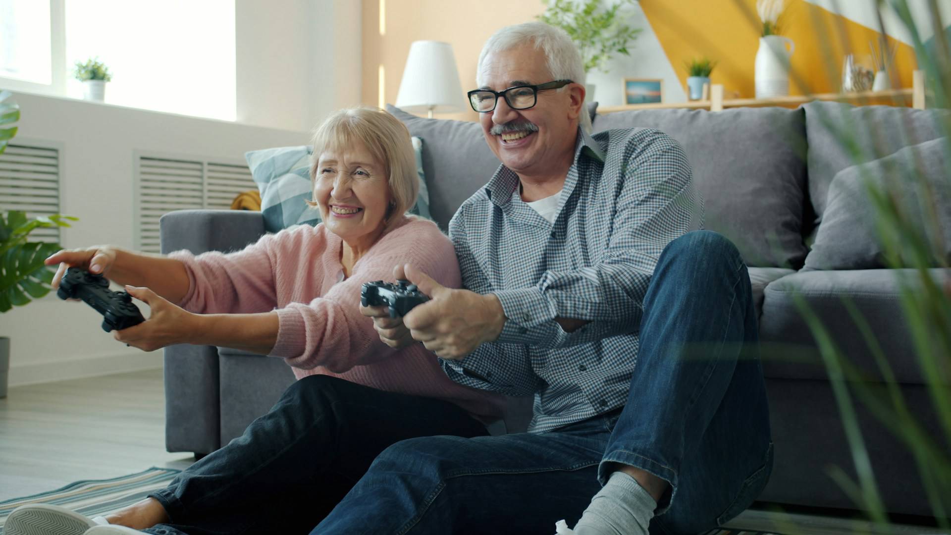 elderly couple playing video games