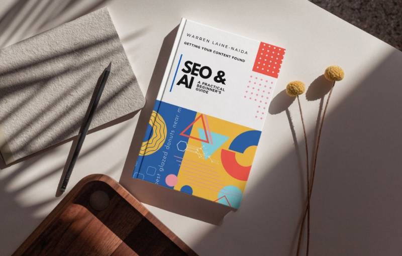 Mockup of SEO & AI paperback on desk by Warren Laine-Naida
